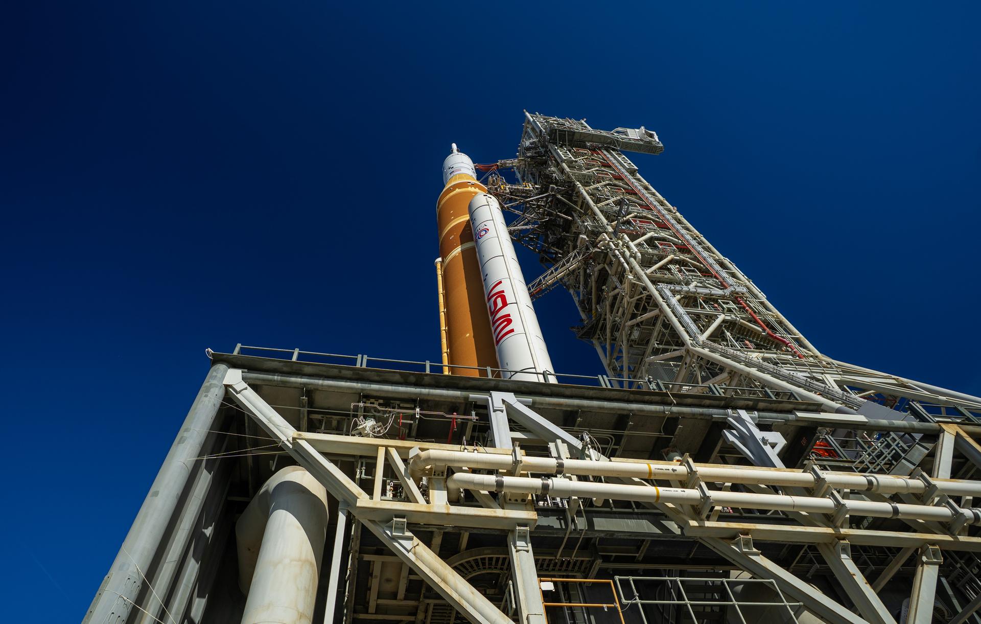 This image shows NASA’s SLS (Space Launch System) and Orion spacecraft rolling out of the Vehicle Assembly Building at NASA’s Kennedy Space Center. NASA's massive Crawler-Transporter, upgraded for the Artemis program, carries the powerful SLS rocket and Orion spacecraft on the Mobile Launcher from the Vehicle Assembly Building to Launch Pad 39B at Kennedy Space Center   in preparation for the Artemis II mission. 